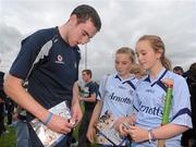 5 August 2011; Dublin hurler Peter Kelly signs autographs for Rebecca Beggins, age 12, right, and Jennifer Dunne, age 11, from Dalkey, Dublin, during an open training session ahead of his side's GAA Hurling All-Ireland Senior Championship Semi-Final match against Tipperary, on August 14th. Dublin Hurling Squad Press Evening, Parnell Park, Dublin. Picture credit: Stephen McCarthy / SPORTSFILE