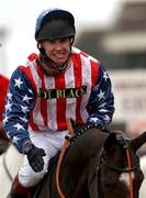 13 March 2002; Richard Johnston celebrates after winning The Queen Mother Champion Steeplechase on Flagship Uberalles during Day Two of the Cheltenham Racing Festival at Prestbury Park in Cheltenham, England. Photo by Matt Browne/Sportsfile