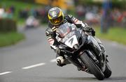 13 August 2011; Guy Martin, England, GSXR 1000cc Suzuki, comes to the final bend on his way to winning the UGP Supporters Club Superbike race 2 during the McKinstry Skip Hire LTD Ulster Grand Prix 2011. Dundrod, Co. Antrim. Picture credit: Barry Cregg / SPORTSFILE