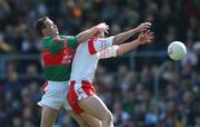 14 April 2002; Cormac McAnallen of Tyrone in action against David Brady of Mayo during the Allianz National Football League Division 1 Semi-Final match between Mayo and Tyrone at Brewster Park in Enniskillen, Fermanagh. Photo by Damien Eagers/Sportsfile