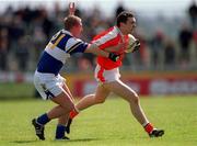14 April 2002; Oisín McConville of Armagh is tackled by David Brennan of Laois during the Allianz National Football League Division 2 Semi-Final match between Armagh and Laois at Pearse Park in Longford. Photo by Ray McManus/Sportsfile