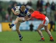 14 April 2002; Michael Lawlor of Laois is tackled by Francie Bellew of Armagh during the Allianz National Football League Division 2 Semi-Final match between Armagh and Laois at Pearse Park in Longford. Photo by Ray McManus/Sportsfile