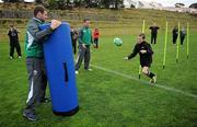 9 September 2011; Ireland players Fergus McFadden and Paddy Wallace go through some drills with Jordan Roylance, age 11, from St Puis School, New Plymouth, during a squad coaching clinic in New Plymouth Boys High School ahead of their Pool C opening game against the USA on Sunday. Ireland Rugby Squad Coaching Clinic, 2011 Rugby World Cup, New Plymouth Boys High School, New Plymouth, New Zealand. Picture credit: Brendan Moran / SPORTSFILE