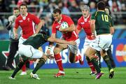 11 September 2011; Wales' Jamie Roberts is tackled by Frans Steyn, left, and Morné Steyn, South Africa. 2011 Rugby World Cup, Pool D, South Africa v Wales, Wellington Regional Stadium, Wellington, New Zealand. Picture credit: Ross Setford  / SPORTSFILE