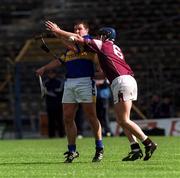 14 April 2002; John Carroll of Tipperary is tackled by Liam Hodgins of Galway during the Allianz National Hurling League Quarter-Final match between Galway and Tipperary at Semple Stadium in Thurles, Tipperary. Photo by Brian Lawless/Sportsfile