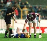 14 April 2002; Eamonn Corcoran of Tipperary lies injured as Eugene Cloonan of Galway and referee Barry Kelly look on during the Allianz National Hurling League Quarter-Final match between Galway and Tipperary at Semple Stadium in Thurles, Tipperary. Photo by Brendan Moran/Sportsfile