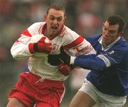 28 April 2002; Gerard Cavlan of Tyrone is tackled by Cathal Collins of Cavan during the Allianz National Football League Division 1 Final match between Tyrone and Cavan at St Tiernach's Park in Clones, Monaghan. Photo by Damien Eagers/Sportsfile