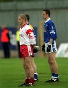 28 April 2002; Kevin Hughes of Tyrone and Thomas Prior of Cavan stand for the playing of the National Anthem prior to the Allianz National Football League Division 1 Final match between Tyrone and Cavan at St Tiernach's Park in Clones, Monaghan. Photo by Damien Eagers/Sportsfile