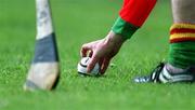 28 April 2002; A Carlow player places the sliotar for a free during the Guinness Leinster Senior Hurling Championship First Round match between Carlow and Meath at Dr Cullen Park in Carlow. Photo by Ray McManus/Sportsfile