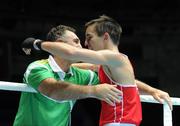 4 October 2011; Michael Conlan, St. John Bosco B.C., Belfast, Antrim, representing Ireland, following his 52kg bout victory over Nordine Oubaali, France, with coach Billy Walsh. Conlan won the contest 20-17 and ensured progression to the Quarter-Finals and also qualification for the London 2012 Olympic Games. 2011 AIBA World Boxing Championships - Last 16, Michael Conlan v Nordine Oubaali. Heydar Aliyev Sports and Exhibition Complex, Baku, Azerbaijan. Picture credit: Stephen McCarthy / SPORTSFILE