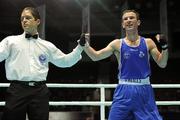 5 October 2011; John Joe Nevin, Cavan B.C., representing Ireland, is announced victorious by referee Gerardo Poggi, Argentina, following his 56kg bout with Orzubek Shayimov, Uzbekistan. Nevin won the contest 19-17 to progress to the Semi-Finals and is guaranteed at least a bronze medal. 2011 AIBA World Boxing Championships - Quarter-Finals, John Joe Nevin v Orzubek Shayimov. Heydar Aliyev Sports and Exhibition Complex, Baku, Azerbaijan. Picture credit: Stephen McCarthy / SPORTSFILE