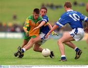 12 May 2002; Eamon McBride, Donegal in action against Ciaran Fitzgerald and Niall Madden, (10) Cavan, Cavan v Donegal, Ulster Minor Football Championship, Breffni Park, Co. Cavan. Picture credit; Pat Murphy / SPORTSFILE