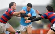 15 October 2011; Corey Hircock, Garryowen, is tackled by Evan Ryan, left, and Sam Cronin, Clontarf. Ulster Bank League, Division 1A, Garryowen v Clontarf, Dooradoyle, Limerick. Picture credit: Diarmuid Greene / SPORTSFILE