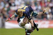 17 October 2004; Jason Johnson, Australia, in action against Steven McDonnell, Ireland. Coca Cola International Rules Series 2004, First Test, Ireland v Australia, Croke Park, Dublin. Picture credit; Brendan Moran / SPORTSFILE *** Local Caption *** Any photograph taken by SPORTSFILE during, or in connection with, the 2004 Coca Cola International Rules Series which displays GAA logos or contains an image or part of an image of any GAA intellectual property, or, which contains images of a GAA player/players in their playing uniforms, may only be used for editorial and non-advertising purposes.  Use of photographs for advertising, as posters or for purchase separately is strictly prohibited unless prior written approval has been obtained from the Gaelic Athletic Association.