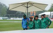 12 May 2017; Bangladesh players stay dry while heading out to greet supporters after the match was called off due to rain at the International between Ireland and Bangladesh at Malahide in Co Dublin. Photo by Cody Glenn/Sportsfile