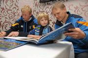 14 November 2011; 9 year old Paddy Breslin, from Churchtown, Co. Dublin, with Leinster Head Coach Joe Schmidt and Leinster's Leo Cullen at the launch of &quot;Rhapsody in Blue&quot;. The book, which has an RRP of €24.95, is on sale from www.leinsterrugby.ie, www.sportsfile.com and from select bookshops nationwide. Launch of &quot;Rhapsody in Blue&quot;, David Lloyd Riverview, Clonskeagh, Dublin. Photo by Sportsfile