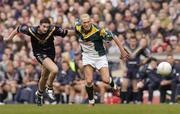 17 October 2004; Ciaran McDonald, Ireland, in action against Brady Rawlings, Australia. Coca Cola International Rules Series 2004, First Test, Ireland v Australia, Croke Park, Dublin. Picture credit; Brian Lawless / SPORTSFILE *** Local Caption *** Any photograph taken by SPORTSFILE during, or in connection with, the 2004 Coca Cola International Rules Series which displays GAA logos or contains an image or part of an image of any GAA intellectual property, or, which contains images of a GAA player/players in their playing uniforms, may only be used for editorial and non-advertising purposes.  Use of photographs for advertising, as posters or for purchase separately is strictly prohibited unless prior written approval has been obtained from the Gaelic Athletic Association.