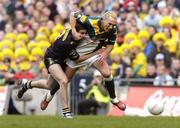 17 October 2004; Ciaran McDonald, Ireland, in action against Brady Rawlings, Australia. Coca Cola International Rules Series 2004, First Test, Ireland v Australia, Croke Park, Dublin. Picture credit; Brian Lawless / SPORTSFILE *** Local Caption *** Any photograph taken by SPORTSFILE during, or in connection with, the 2004 Coca Cola International Rules Series which displays GAA logos or contains an image or part of an image of any GAA intellectual property, or, which contains images of a GAA player/players in their playing uniforms, may only be used for editorial and non-advertising purposes.  Use of photographs for advertising, as posters or for purchase separately is strictly prohibited unless prior written approval has been obtained from the Gaelic Athletic Association.