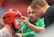 24 November 2011; John Mullally, from Dublin, has a cut attended to by his coaches Jonathan Lewins, right, and Jimmy Upton during his 91+ kg Quarter-Final bout against Ivan Tkachenko, from Ukraine. 2011 WAKO World Kickboxing Championships, Citywest Conference Centre, Saggart, Dublin. Picture credit: Matt Browne / SPORTSFILE