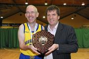 26 November 2011; Navan Arch Club, Co. Meath, captain Fiacra Englishby is presented with the Division 2 championship plate by Special Olympics Ireland CEO Matt English. 2011 Special Olympics Ireland National Basketball Cup - Men, National Basketball Arena, Tallaght, Dublin. Picture credit: Barry Cregg / SPORTSFILE