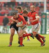 18 December 2011; Damien Varley, supported by BJ Botha, Munster, is tackled by Rhodri Jones, Scarlets. Heineken Cup, Pool 1, Round 4, Munster v Scarlets, Thomond Park, Limerick. Picture credit: Diarmuid Greene / SPORTSFILE