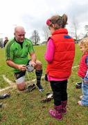 22 December 2011; Munster's John Hayes in conversation with his daughters Sally, aged 5, centre, and Roisin, aged 2 and a half, right, as he changes his boots during squad training ahead of their Celtic League game against Connacht on Monday. Munster Rugby Squad Training, Kilballyowen Park, Bruff, Co. Limerick. Picture credit: Diarmuid Greene / SPORTSFILE