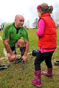 22 December 2011; Munster's John Hayes in conversation with his daughter Sally, aged 5, as he changes his boots during squad training ahead of their Celtic League game against Connacht on Monday. Munster Rugby Squad Training, Kilballyowen Park, Bruff, Co. Limerick. Picture credit: Diarmuid Greene / SPORTSFILE