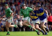 2 June 2002; Mark Keane of Limerick is tackled by Thomas Costello, left, and Donnacha Fahy of Tipperary during the Guinness Munster Senior Hurling Championship Semi-Final match between Tipperary and Limerick at Páirc U’ Chaoimh in Cork. Photo by Brendan Moran/Sportsfile