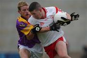 8 June 2002; Tyrone's Sean Cavanagh is tackled by Wexford's Niall Murphy during the Bank of Ireland All-Ireland Senior Football Championship Qualifier Round 1 match between Wexford and Tyrone at Wexford Park in Wexford. Photo by Aoife Rice/Sportsfile