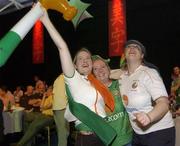 11 June 2002; Republic of Ireland supporters, from left, Vanessa Tucker from Leixlip, Niamh O'Farrell from Goatstown and Clare Kavanagh from Kildare celebrate following their side's victory during the FIFA World Cup 2002 Group E match between Saudi Arabia and Republic of Ireland at the 'Big In Japan' event at the RDS in Ballsbridge, Dublin. Photo by Aoife Rice/Sportsfile