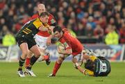 12 November 2011; Peter O'Mahony, Munster, is tackled by Dylan Hartley, left, and Lee Dickson, Northampton Saints. Heineken Cup, Pool 1, Round 1, Munster v Northampton Saints, Thomond Park, Limerick. Picture credit: Diarmuid Greene / SPORTSFILE