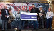 9 June 2017; Matchroom Boxing promoter Eddie Hearn presents a cheque to Gerry Storey of the Holy Family Boxing Club during the weigh ins ahead of the Boxing in Belfast event in the Hilton Hotel, Belfast. Photo by David Fitzgerald/Sportsfile