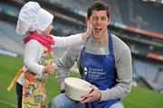 9 February 2012; Dublin football player and Acquired Brain Injury Ireland Ambassador Rory O'Carroll swaps his Dublin jersey for an Acquired Brain Injury Ireland apron, to launch the organisations national fundraising campaign Bake for Brain Injury; with Ruby Dodd, age 4, from Monkstown, Co. Dublin. The 'Bake for Brain Injury'; campaign is an annual fundraiser developed by ABI Ireland in an effort to raise much needed funds, for those living with an Acquired Brain Injury. 'Bake for Brain Injury' will take place during Brain Awareness Week March 5th-11th 2012; encouraging people to bake and donate much needed funds online at www.abiireland.ie. Croke Park, Dublin. Picture credit: David Maher / SPORTSFILE