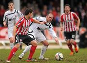 11 February 2012; David McDaid, Derry City, in action against Aaron Callaghan, Lisburn Distillery. Setanta Sports Cup, First Round, First Leg, Lisburn Distillery v Derry City, New Grosvenor Stadium, Lisburn, Co. Antrim. Picture credit: Oliver McVeigh / SPORTSFILE