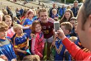 1 July 2017; Amy Lillis, aged 10, from The Ragg, Co. Tipperary gets her photograph taken with Noel McGrath of Tipperary after the GAA Hurling All-Ireland Senior Championship Round 1 match between Tipperary and Westmeath at Semple Stadium in Thurles, Co Tipperary. Photo by Diarmuid Greene/Sportsfile
