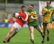 7  July 2002; Ronan Clarke, Armagh, in action   against Donegal's John Gildea, centre and Paul McGonigle, right. Armagh v Donegal, Ulster Football Final, St Tighearnachs Park, Clones, Co. Monaghan. Picture credit; Damien Eagers / SPORTSFILE
