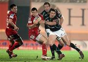 2 March 2012; Adam Warren, Scarlets, supported by team-mate Dan Newton, is tackled by Dave McSharry, Connacht, supported by team-mate Michael Swift. Celtic League, Scarlets v Connacht, Parc Y Scarlets, Llanelli, Wales. Picture credit: Steve Pope / SPORTSFILE