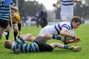 14 March 2012; Johnny Guy, St. Andrew’s College, scores his side's second try despite the efforts of Adam Simmonds, St. Gerard’s School. Fr. Godfrey Cup Final, St. Gerard’s School v St. Andrew’s College, Templeville Road, Dublin. Picture credit: Brian Lawless / SPORTSFILE