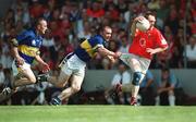 21 July 2002; Philip Clifford of Cork has his shorts pulled by Niall Fitzgerald of Tipperary as Niall Kelly, left, looks on during the Bank of Ireland Munster Football Final Replay match between Cork and Tipperary at Páirc Uí Chaoimh in Cork. Photo by Brendan Moran/Sportsfile