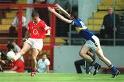 21 July 2002; Fionan Murray of Cork kicks a point despite the efforts of Robbie Costigan of Tipperary during the Bank of Ireland Munster Football Final Replay match between Cork and Tipperary at Páirc Uí Chaoimh in Cork. Photo by Brendan Moran/Sportsfile