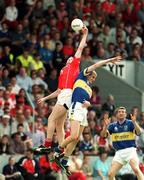 21 July 2002; Nicholas Murphy of Cork fields a high ball above Kevin Mulryan of Tipperary as Brendan Cummins, right, looks on during the Bank of Ireland Munster Football Final Replay match between Cork and Tipperary at Páirc Uí Chaoimh in Cork. Photo by Brendan Moran/Sportsfile