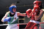 23 March 2012; Katie Taylor, Ireland, left, exchanges punches with Jessica Belder, Holland, during their 60kg bout. Women's Boxing International, Ireland v Holland, National Stadium, Dublin. Picture credit: Barry Cregg / SPORTSFILE