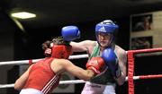 23 March 2012; Michelle Lynch, Ireland, right, exchanges punches with Bianca Elmir, Holland, during their 54kg bout. Women's Boxing International, Ireland v Holland, National Stadium, Dublin. Picture credit: Barry Cregg / SPORTSFILE