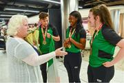 24 July 2017; Team Ireland Athletes, from left,  John Fitzsimons, who won bronze in the men’s 800m, Gina Apke-Moses, who won gold in the 100m, and Michaela Walsh, who won bronze in the Hammer, are presented with flowers by Athletics Ireland President Georgina Drumm at the homecoming of the Irish Team from the European Athletics Under-20 Championships in Italy at Dublin Airport.  Photo by Sam Barnes/Sportsfile