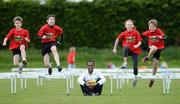 13 April 2012; Kenenisa Bekele, reigning Olympic champion at 5,000 metres and 10,000 metres and current world record holder at both distances paid a surprise visit to Enniskerry AC junior athletes as they prepared for the SPAR Great Ireland Mini Run and Junior Run which take place in the Phoenix Park, Dublin on Sunday 15th April with over 11,000 adults and children participating. Pictured with Kenenisa Bekeleare are, from left to right, Ben Jones, Luke Dillon, Lara Gillespie and Ted Crossingham, all from Enniskerry AC. St Mary’s GAA Club, Enniskerry, Co. Wicklow. Picture credit: Matt Browne / SPORTSFILE