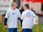 13 April 2012; Dundalk's Derek Foran, left, and Shane O'Neill, wearing t-shirts highlighting 'cardiac risk in the young', during the warm up. Airtricity League Premier Division, Shamrock Rovers v Dundalk, Tallaght Stadium, Tallaght, Co. Dublin. Picture credit: David Maher / SPORTSFILE