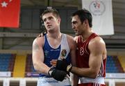 16 April 2012; A dejected Joe Ward, Ireland, left, is consoled by Bahram Muzaffer, Turkey, after he was declared the winner at the end of their Light Heavyweight 81kg bout. AIBA European Olympic Boxing Qualifying Championships, Hayri Gür Arena, Trabzon, Turkey. Picture credit: David Maher / SPORTSFILE