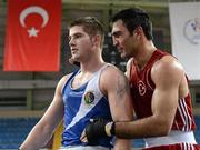 16 April 2012; A dejected Joe Ward, Ireland, left, is consoled by Bahram Muzaffer, Turkey, after he was declared the winner at the end of their Light Heavyweight 81kg bout. AIBA European Olympic Boxing Qualifying Championships, Hayri Gür Arena, Trabzon, Turkey. Picture credit: David Maher / SPORTSFILE
