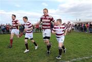 15 April 2012; Tullow RFC team captain Frank Murphy leads his team out alongside the Tullow mascots for the start of the game. Provincial Towns Cup Final, Tullow RFC v Enniscorthy RFC, Portarlington RFC, Portarlington, Co Laois. Picture credit: Matt Browne / SPORTSFILE