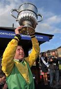 24 April 2012; Jockey Andrew Lynch celebrates with the Blessington cup after winning the Boylesports.com Champion Steeplechase aboard Sizing Europe. Punchestown Racing Festival, Punchestown Racecourse, Punchestown, Co. Kildare. Picture credit: Barry Cregg / SPORTSFILE